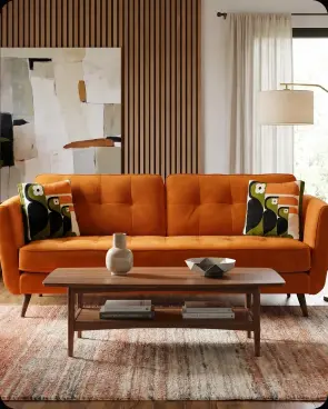An orange sofa with bird-print cushions