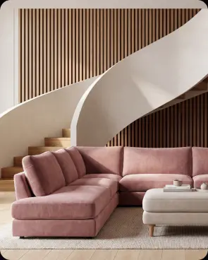 A pink curved sofa beneath a staircase