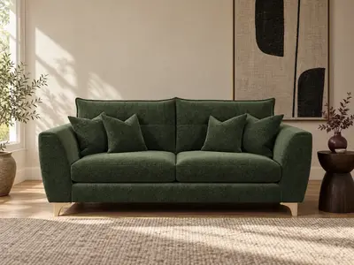 A green sofa in a panelled room