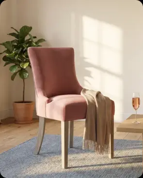 A pink dining chair in a sunlit room