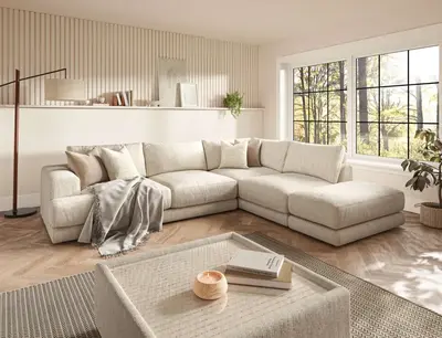 A cream corner sofa in a light living room