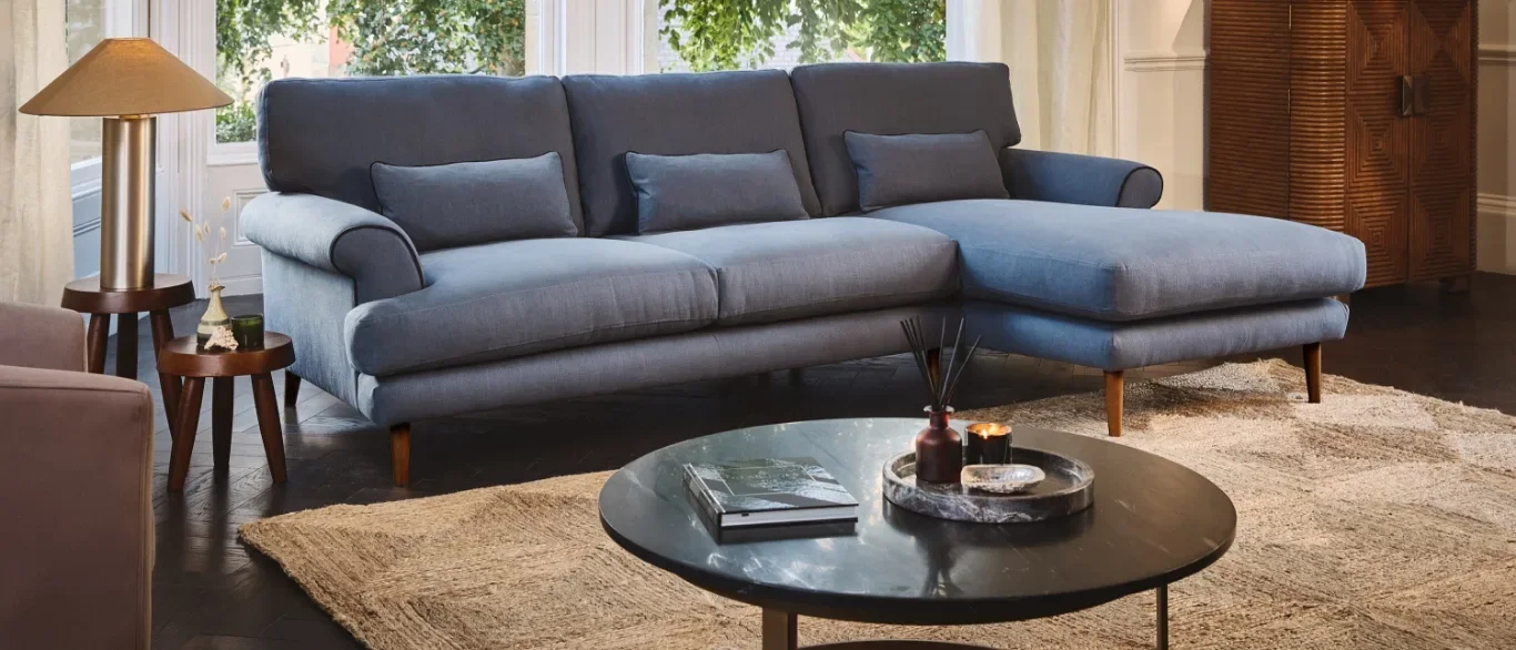 A blue-grey Darlings chaise sofa in a panelled room, photographed by Darlings