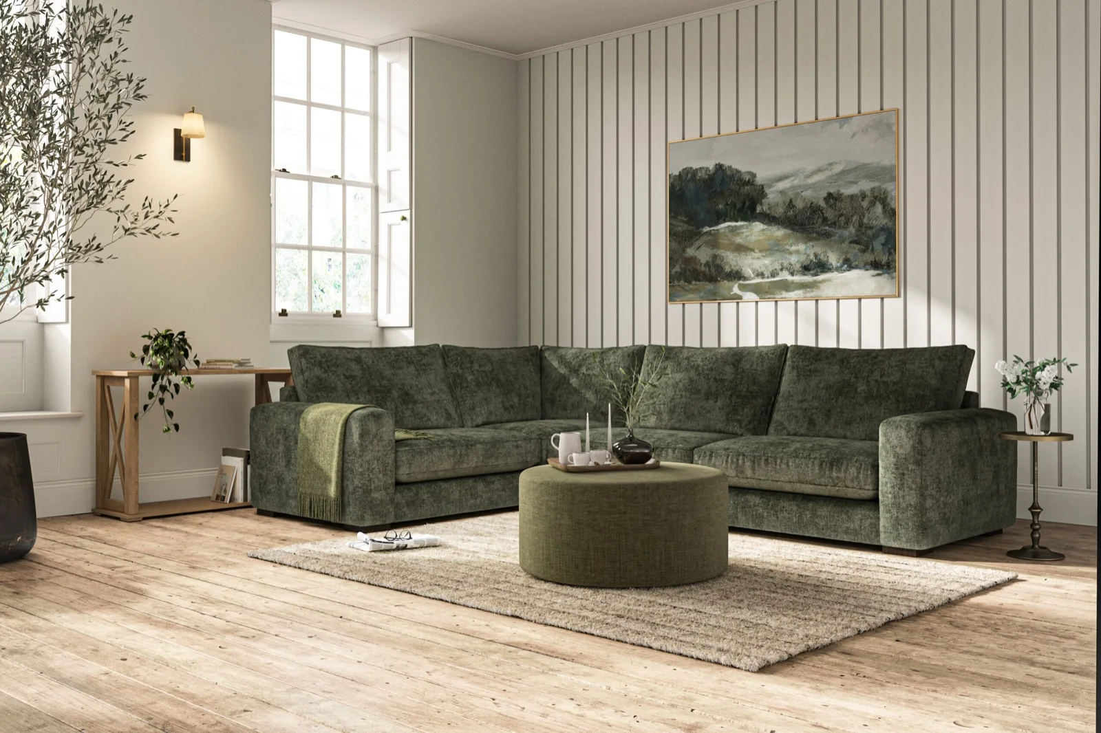A green velvet Tamarisk corner sofa with a matching footstool