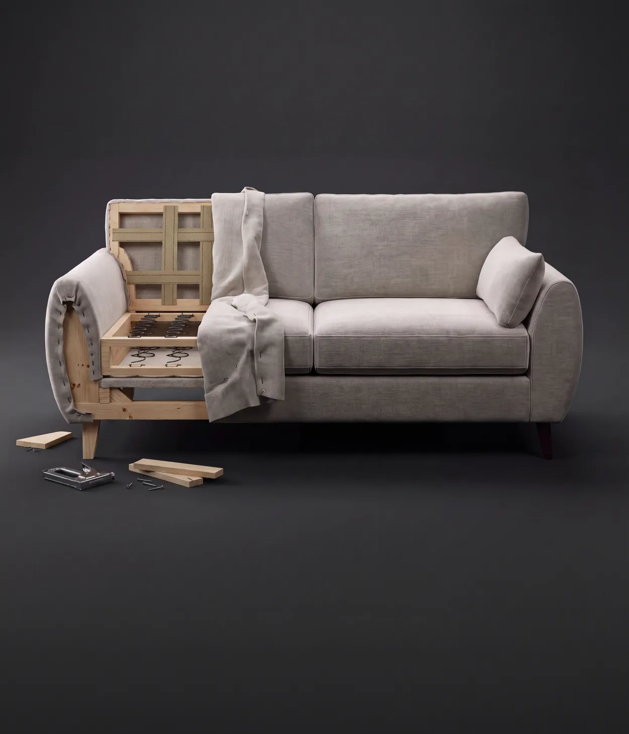 A sofa half-upholstered and half-finished, showing its timber frame and springs