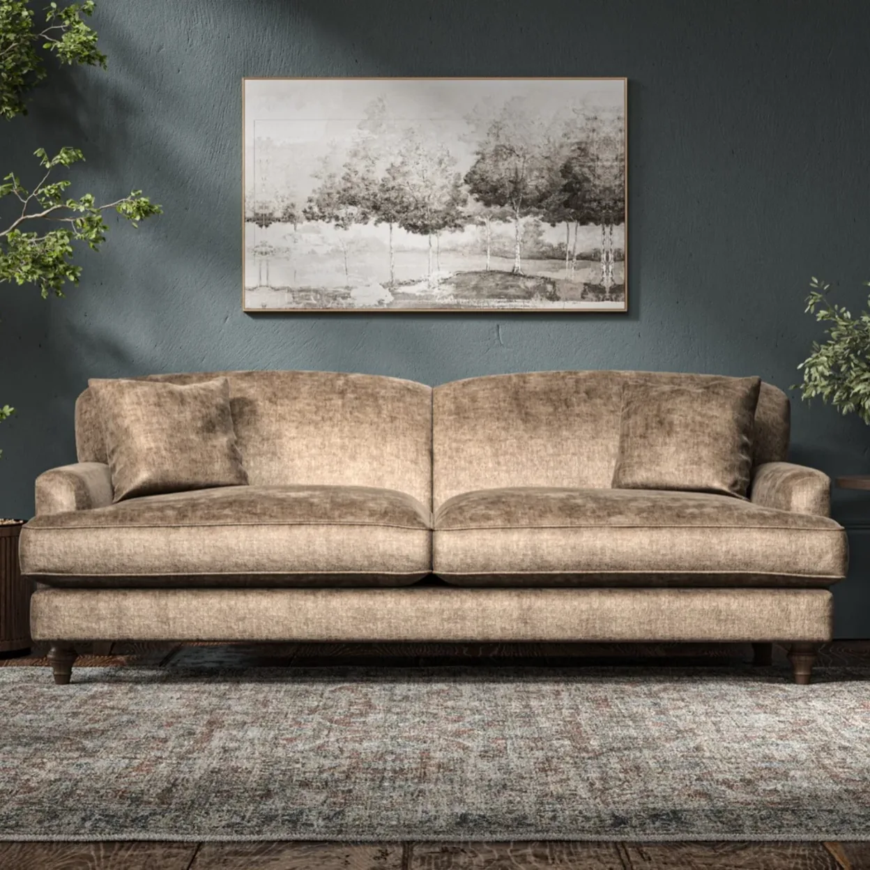 A gold velvet sofa against a deep teal wall