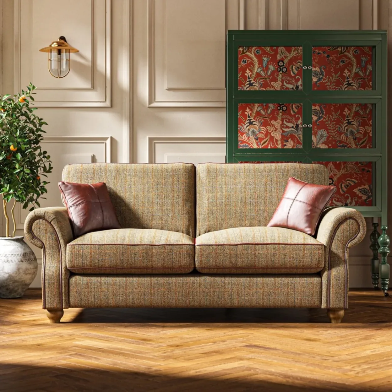 A tweed sofa beside a painted dresser in a paneled room
